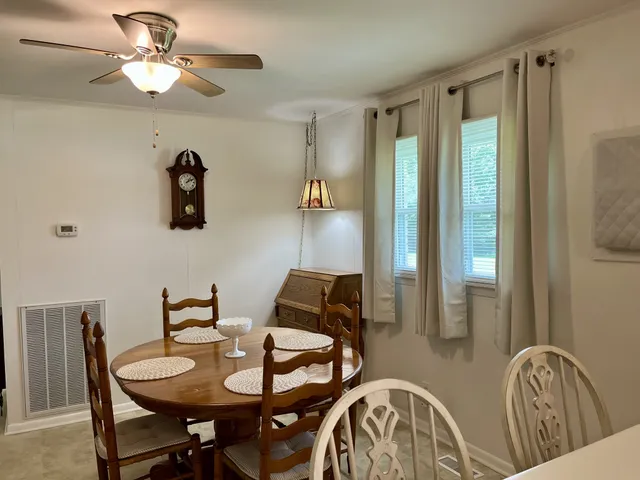 a view of a dining room with furniture and chandelier