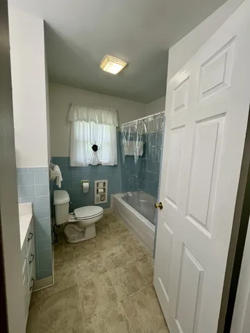 a bathroom with a toilet a sink and shower