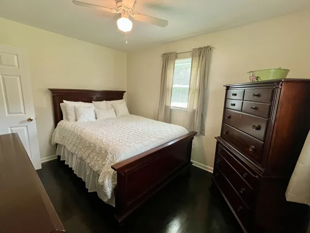 a bedroom with a bed and dresser