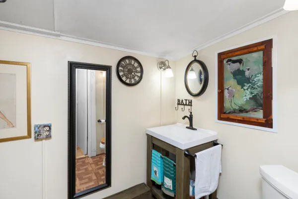 a bedroom with a bed and a glass door shower