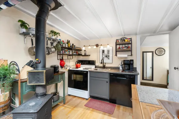 a kitchen with lots of clutter and stainless steel appliances