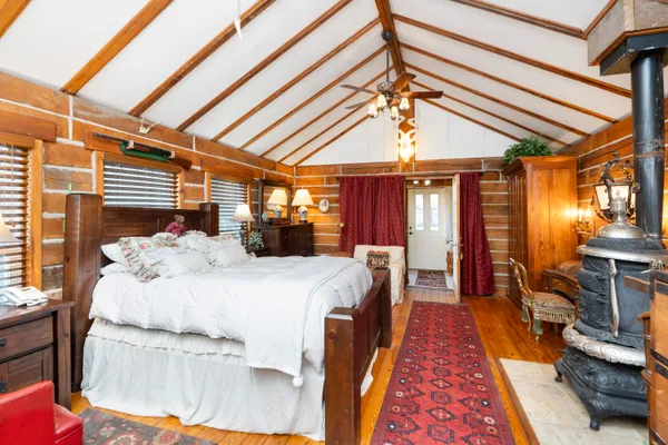 a room with water heater and wooden cabinets