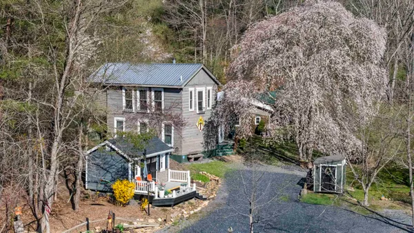 a view of balcony with wooden floor and outdoor seating