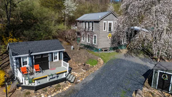 a view of a tiny house with a yard