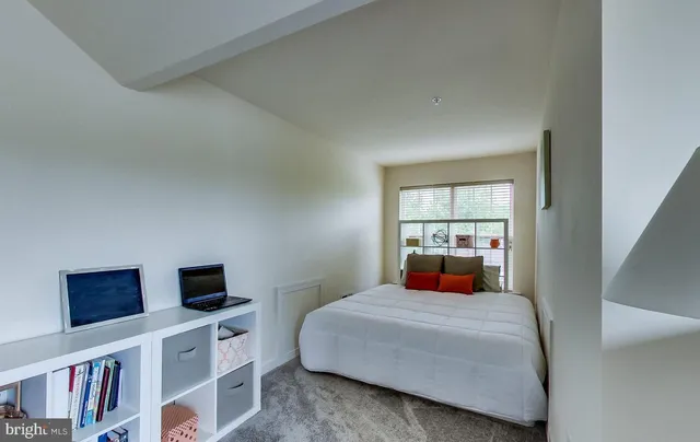 a room with a dresser and a window