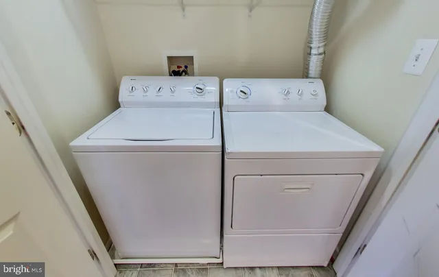 a living room with furniture a flat screen tv and a window