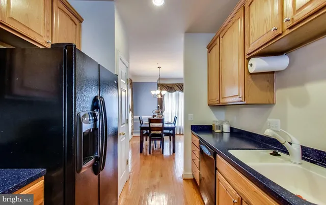 a living room with furniture and a dining table with kitchen view