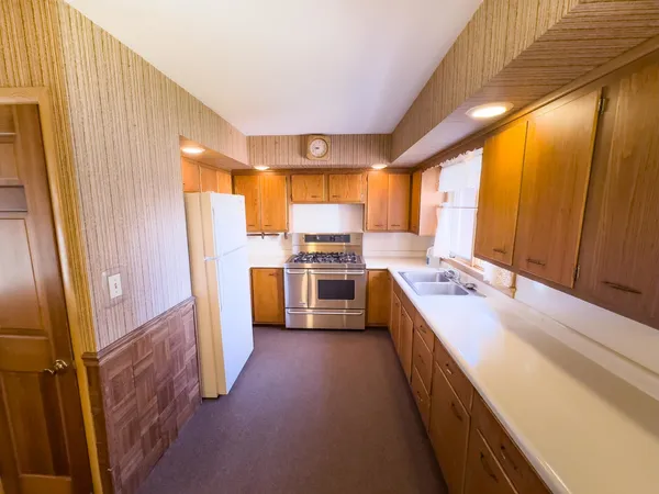 a kitchen with refrigerator a sink and cabinets