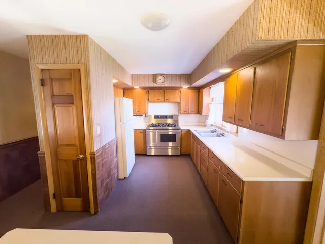a large kitchen with a large window