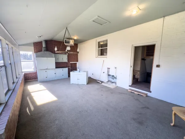a view of a kitchen with a refrigerator and a sink