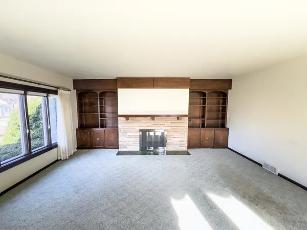 an empty room with furniture and a fireplace