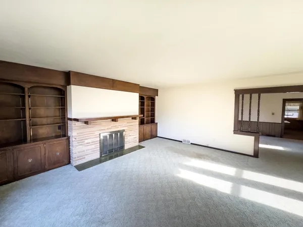 a view of a livingroom with furniture and an empty room