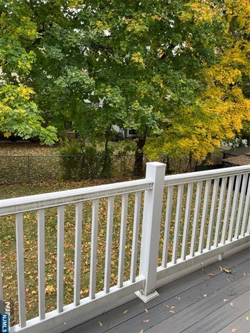 a view of a wooden fence and trees