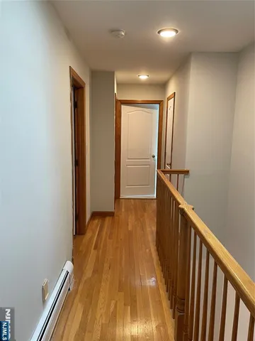 a view of hallway with wooden floor