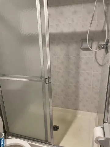 a bathroom with a glass shower door