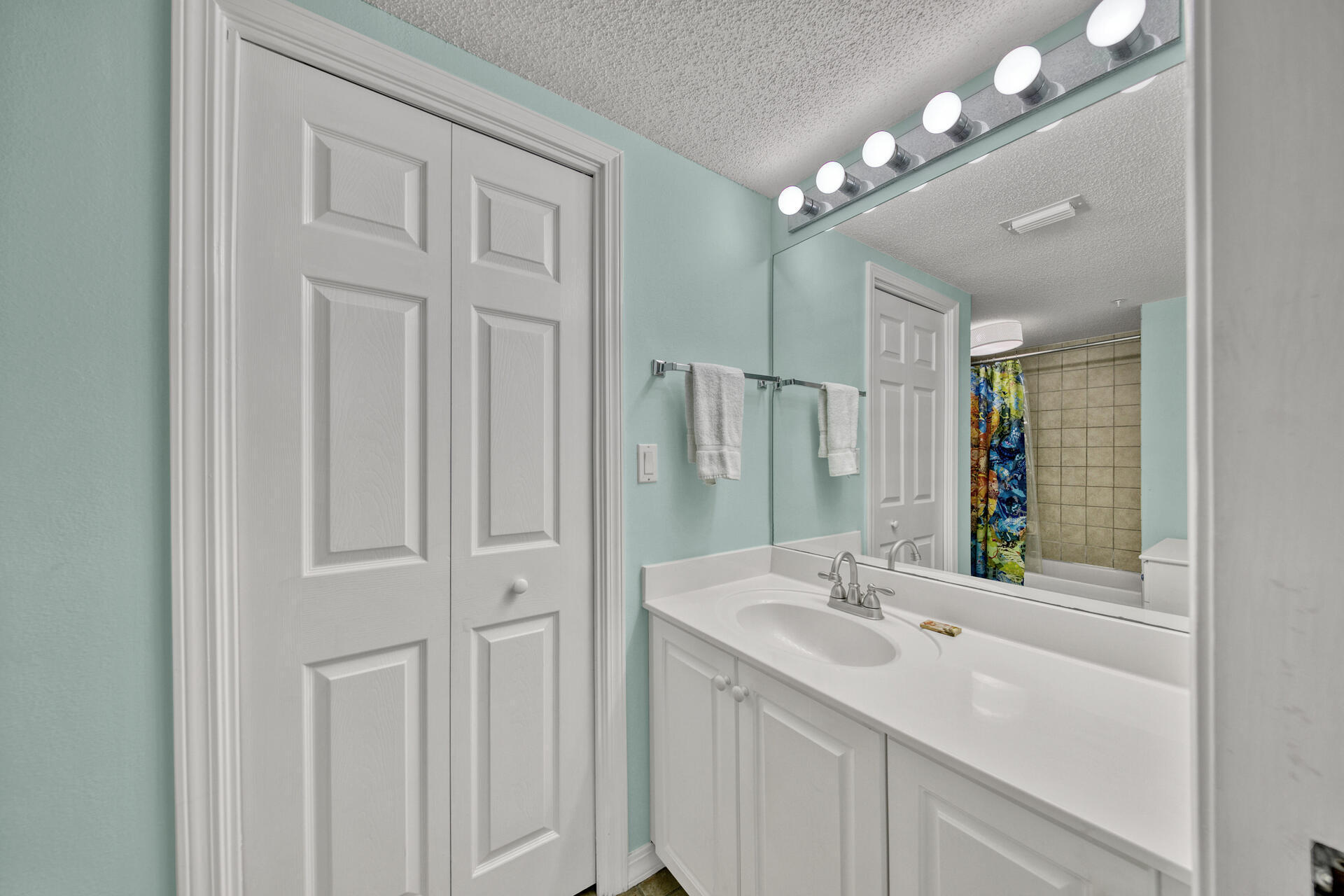 520 Santa Rosa Boulevard, Unit 111 Fort Walton Beach, FL 32548 - Photo 25 of 38 a bathroom with a sink vanity and a mirror