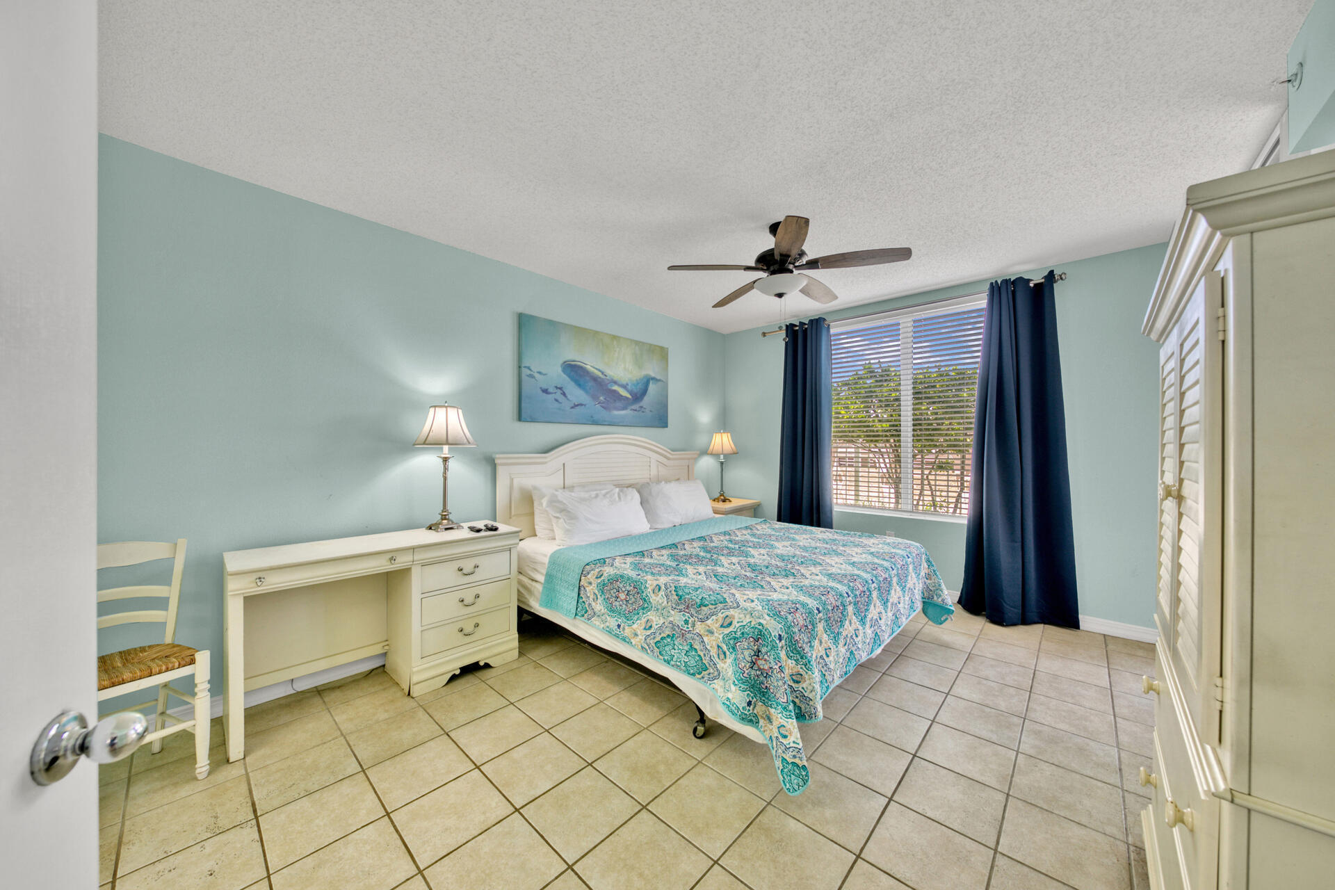 520 Santa Rosa Boulevard, Unit 111 Fort Walton Beach, FL 32548 - Photo 27 of 38 a bedroom with a large bed and a chandelier