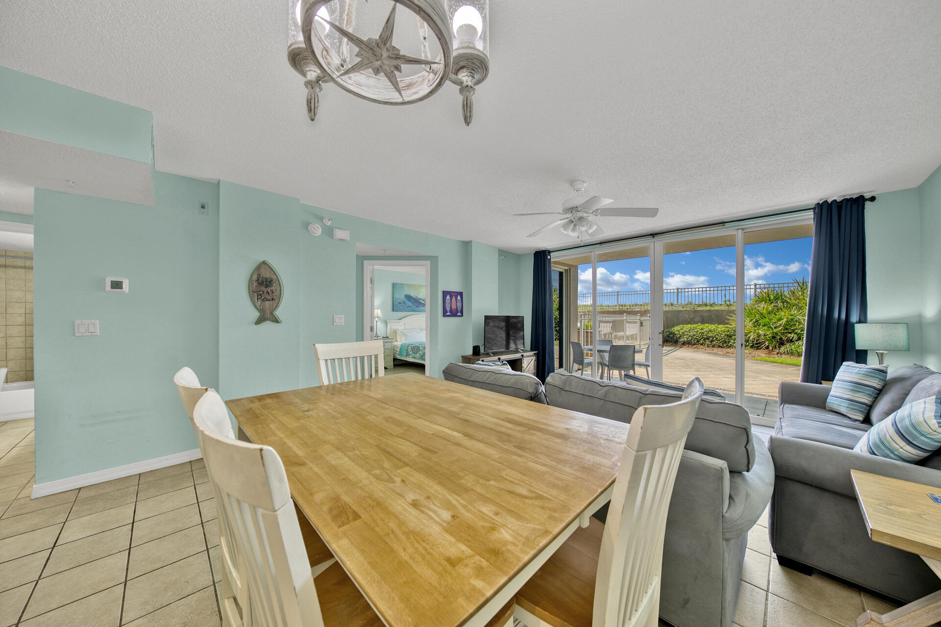 520 Santa Rosa Boulevard, Unit 111 Fort Walton Beach, FL 32548 - Photo 30 of 38 a view of a dining room with furniture large windows and wooden floor