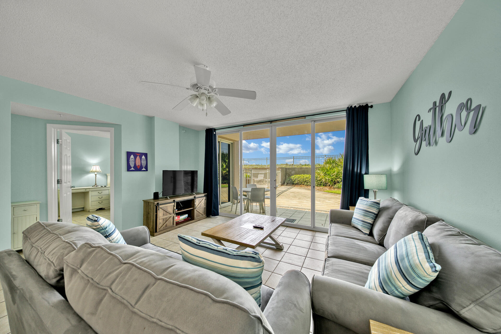 520 Santa Rosa Boulevard, Unit 111 Fort Walton Beach, FL 32548 - Photo 31 of 38 a living room with furniture large window and a flat screen tv