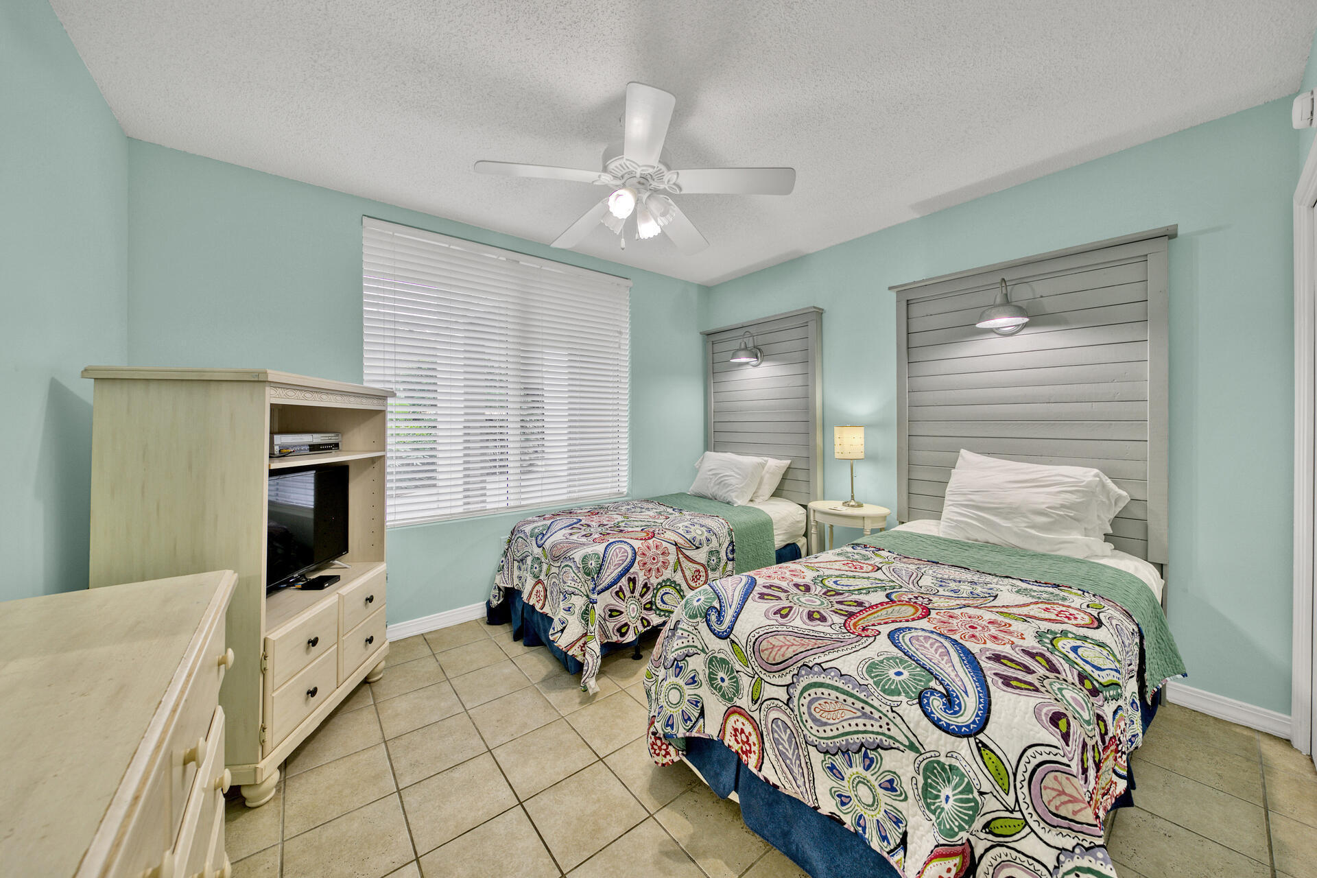 520 Santa Rosa Boulevard, Unit 111 Fort Walton Beach, FL 32548 - Photo 6 of 38 a bedroom with two beds and a chandelier