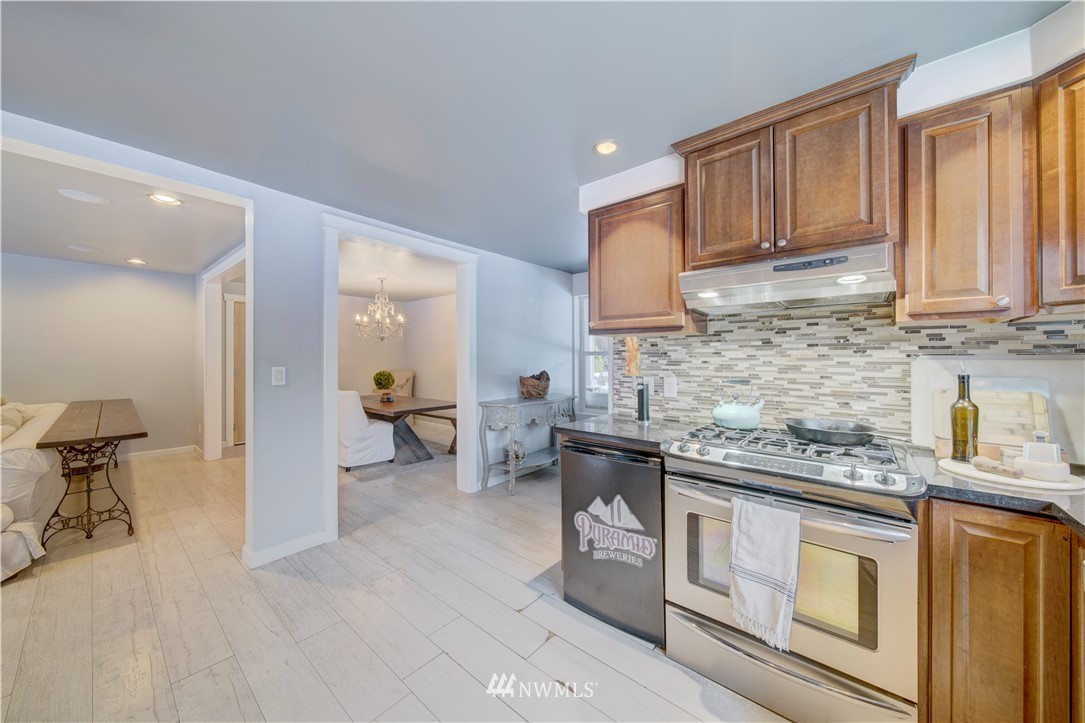 314 Russell Road Snohomish, WA 98290 - Photo 9 of 23 a kitchen with stainless steel appliances granite countertop a stove a sink dishwasher and cabinets with wooden floor