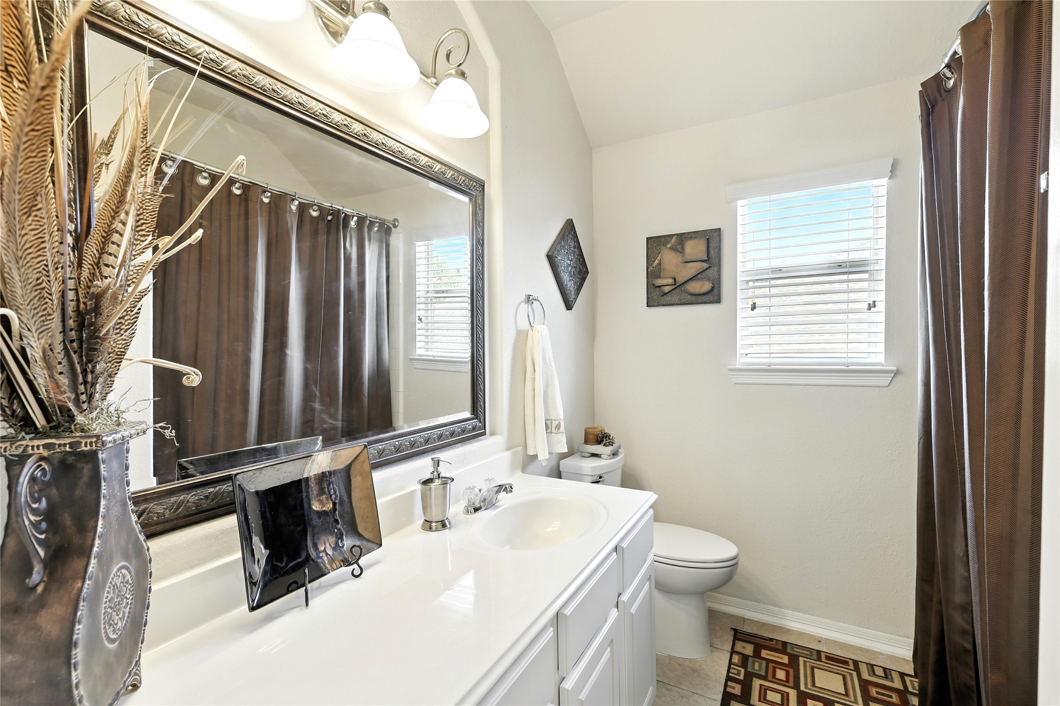 25218 Piney Heights Lane Spring, TX 77389 - Photo 28 of 40 a bathroom with a sink a toilet and mirror