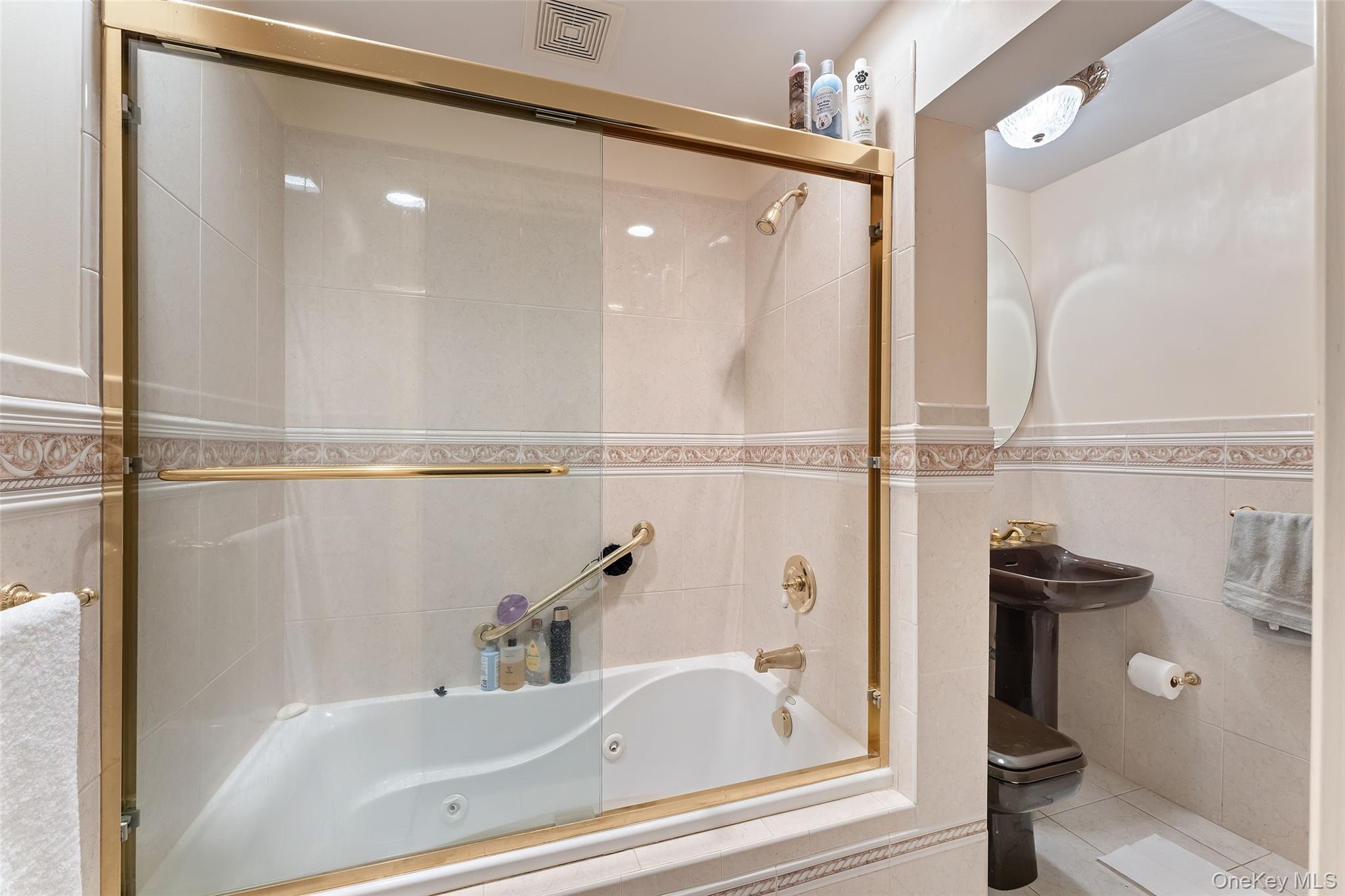 105 Cross Pond Road Pound Ridge, NY 10576 - Photo 38 of 49 a bathroom with a bathtub and a shower