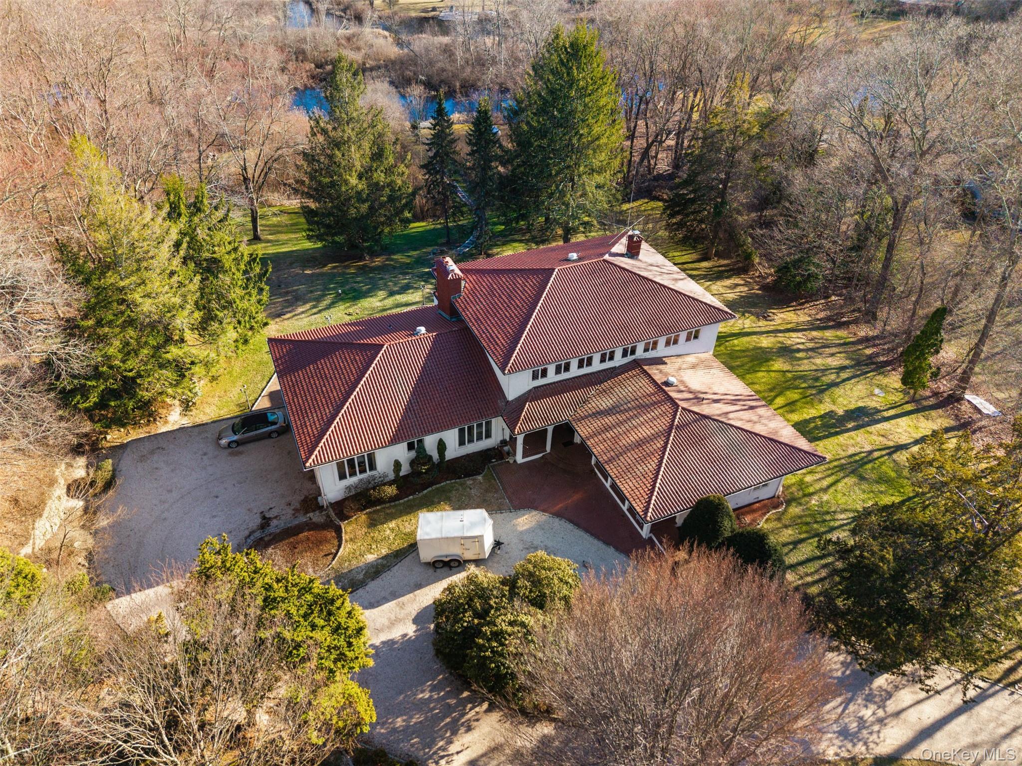 105 Cross Pond Road Pound Ridge, NY 10576 - Photo 41 of 49 an aerial view of a house with a yard basket ball court and outdoor seating