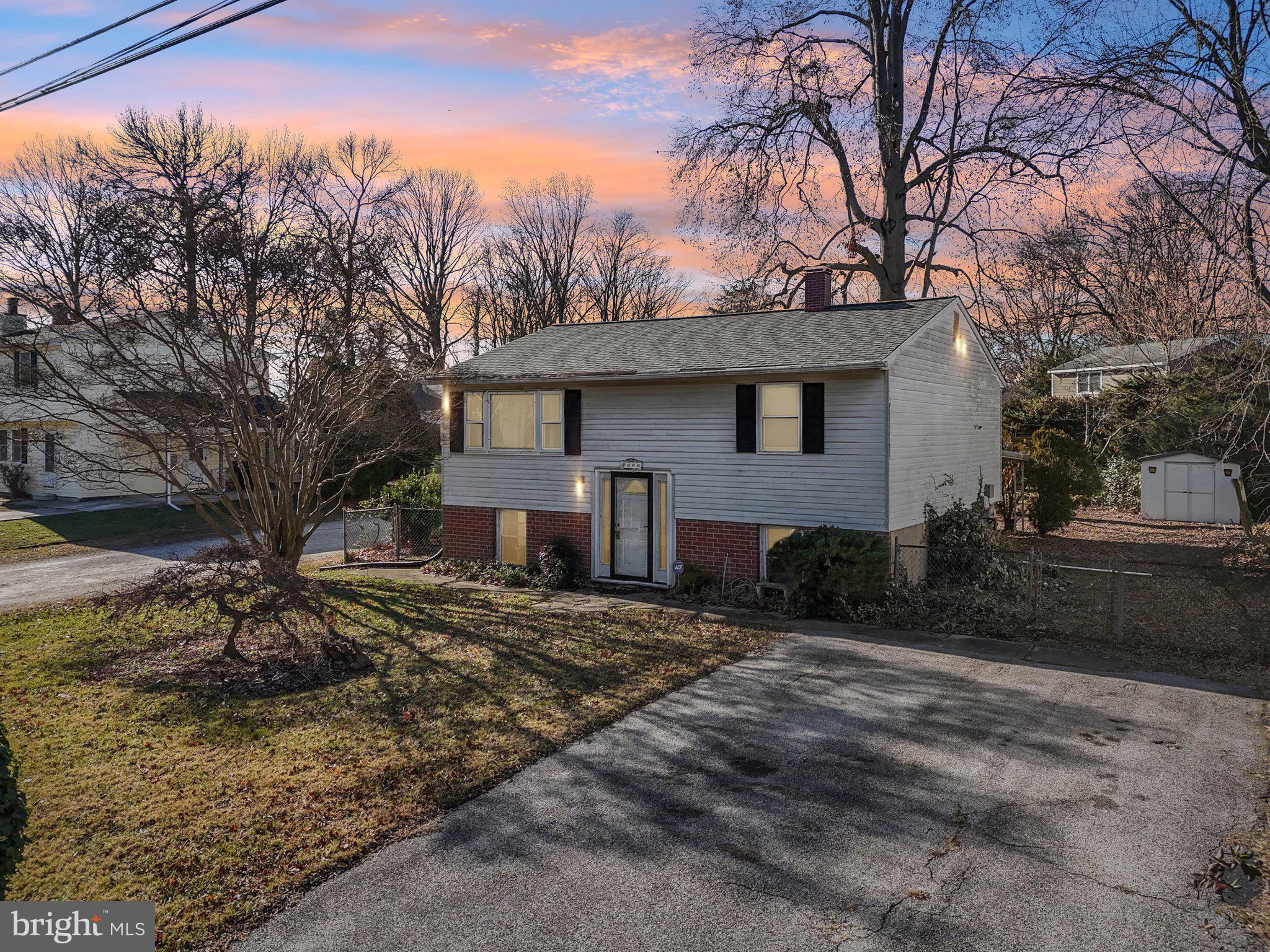 a view of a house with a yard covered with snow in the background