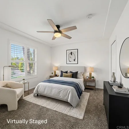 a bedroom with a bed a couch and a window