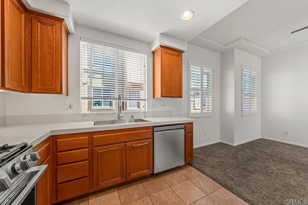 a kitchen with a sink stove and cabinets