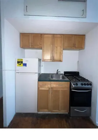 a kitchen with a stove and a refrigerator