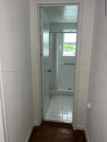 a view of an empty room with mirror