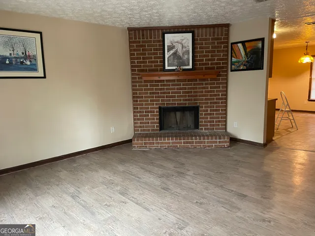 a view of empty room with a fireplace