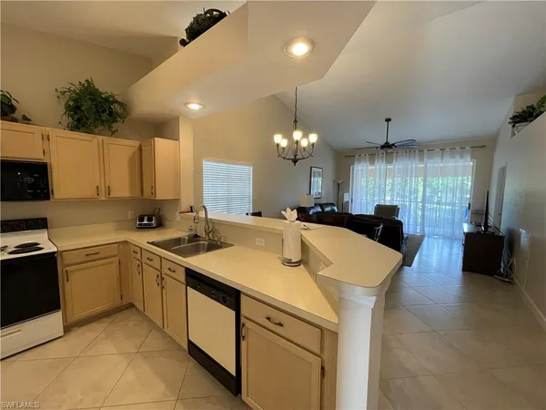 a large kitchen with a sink and cabinets