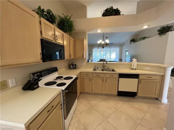 a kitchen with a sink a stove and cabinets