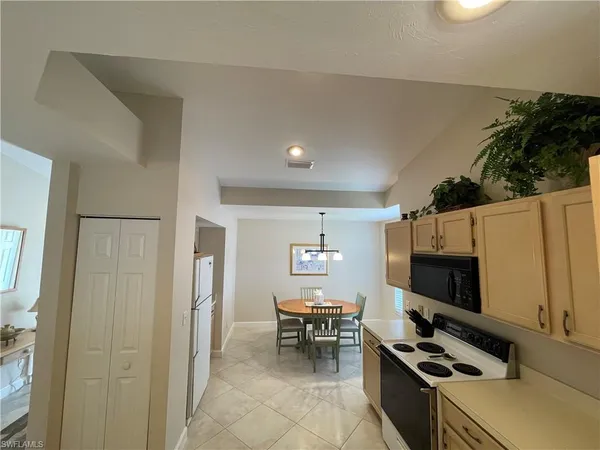 a kitchen with a refrigerator and a stove top oven