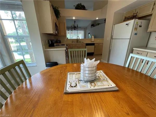 a view of kitchen with sink and refrigerator