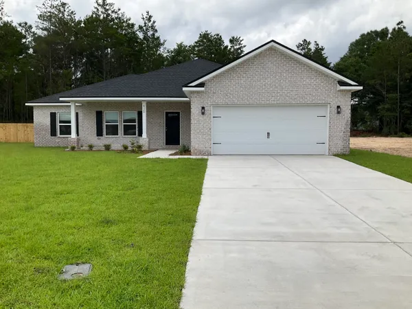 a front view of house with yard and green space