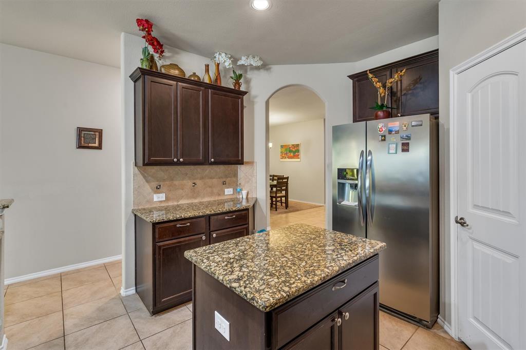 520 Rustic Oak Lane McKinney, TX 75072 - Photo 11 of 37 a kitchen with granite countertop a sink cabinets and stainless steel appliances