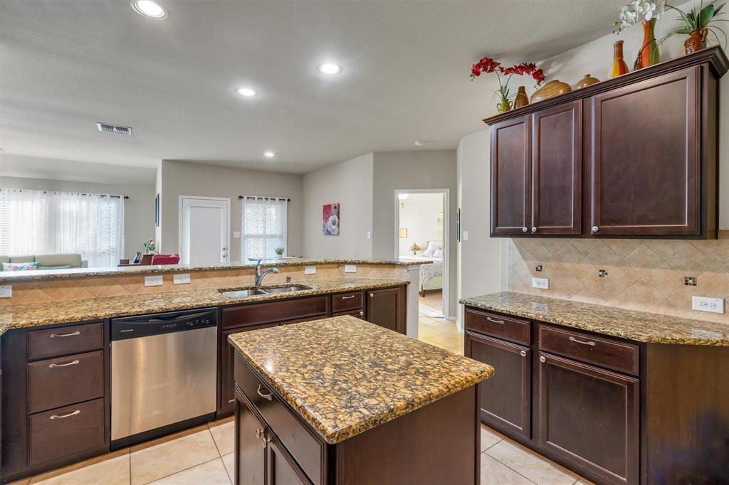 520 Rustic Oak Lane McKinney, TX 75072 - Photo 12 of 37 a kitchen with stainless steel appliances granite countertop a sink stove and cabinets