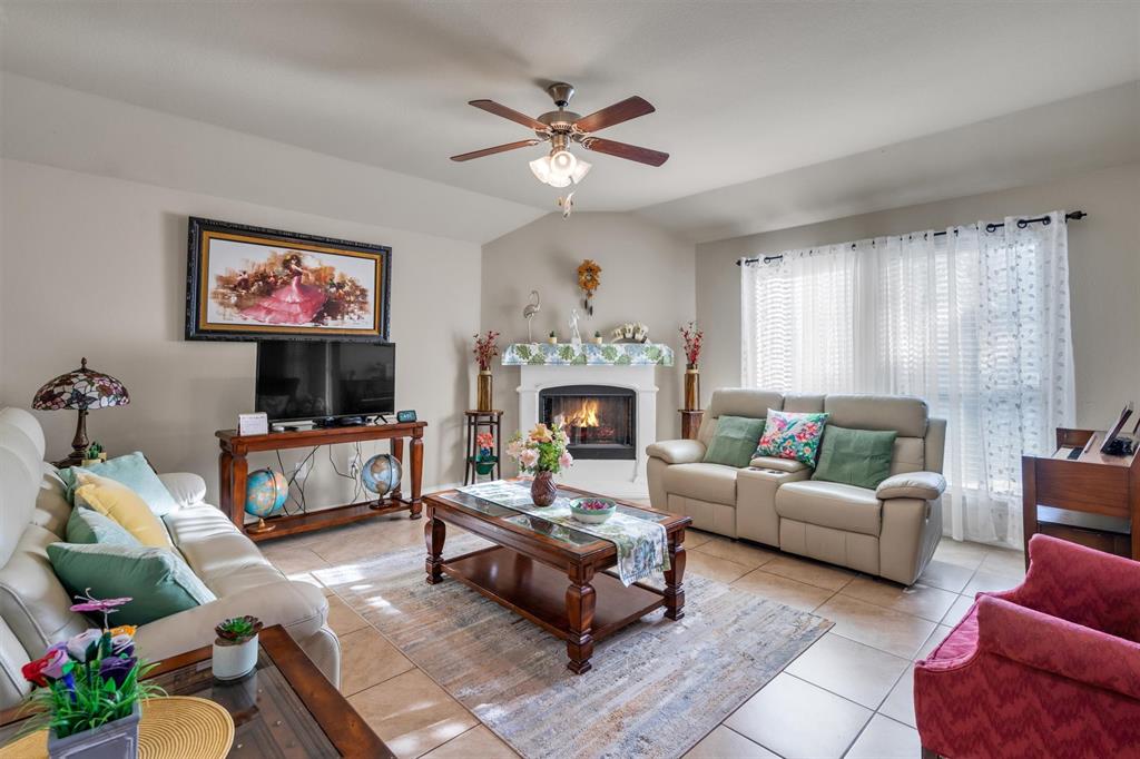 520 Rustic Oak Lane McKinney, TX 75072 - Photo 15 of 37 a living room with furniture and a fireplace