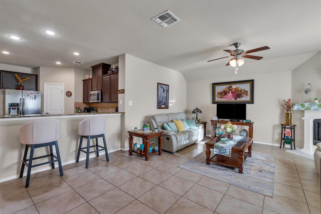 520 Rustic Oak Lane McKinney, TX 75072 - Photo 16 of 37 a living room with furniture and a flat screen tv