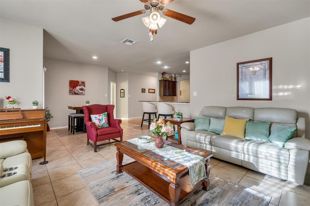 520 Rustic Oak Lane McKinney, TX 75072 - Photo 18 of 37 a living room with furniture and a chandelier