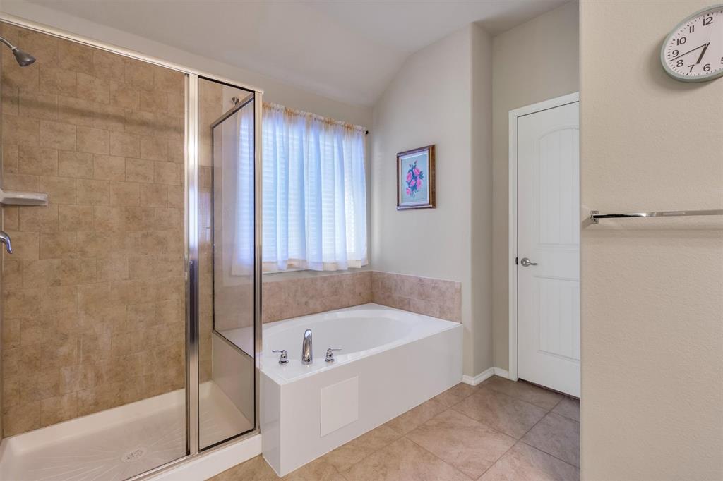 520 Rustic Oak Lane McKinney, TX 75072 - Photo 25 of 37 a bathroom with a bathtub and a shower