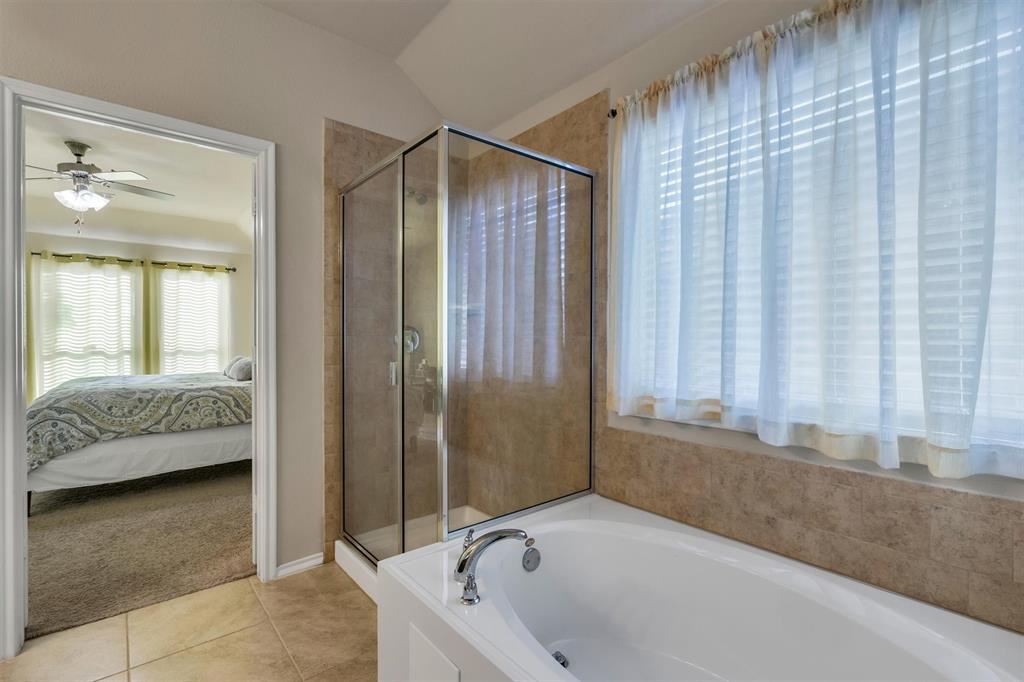 520 Rustic Oak Lane McKinney, TX 75072 - Photo 26 of 37 a bathroom with a tub and shower