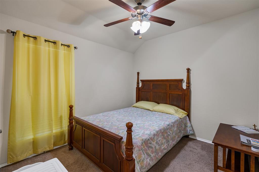 520 Rustic Oak Lane McKinney, TX 75072 - Photo 30 of 37 a bedroom with a bed and a chandelier