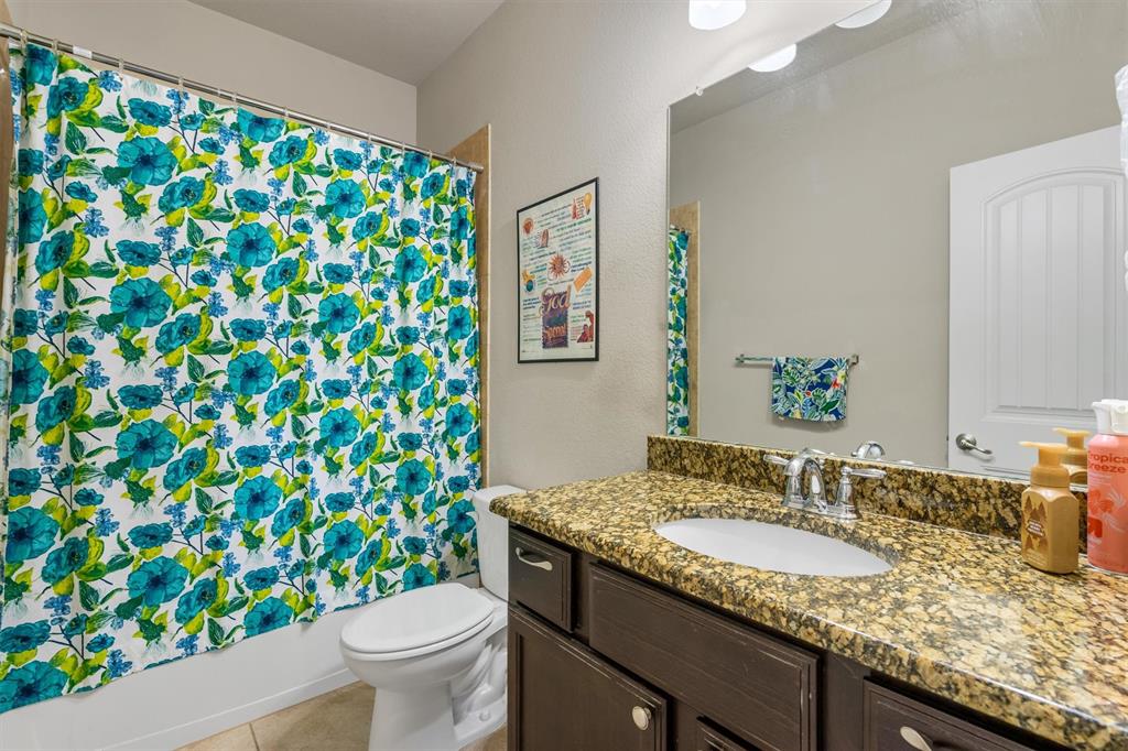 520 Rustic Oak Lane McKinney, TX 75072 - Photo 31 of 37 a bathroom with a granite countertop sink and a mirror