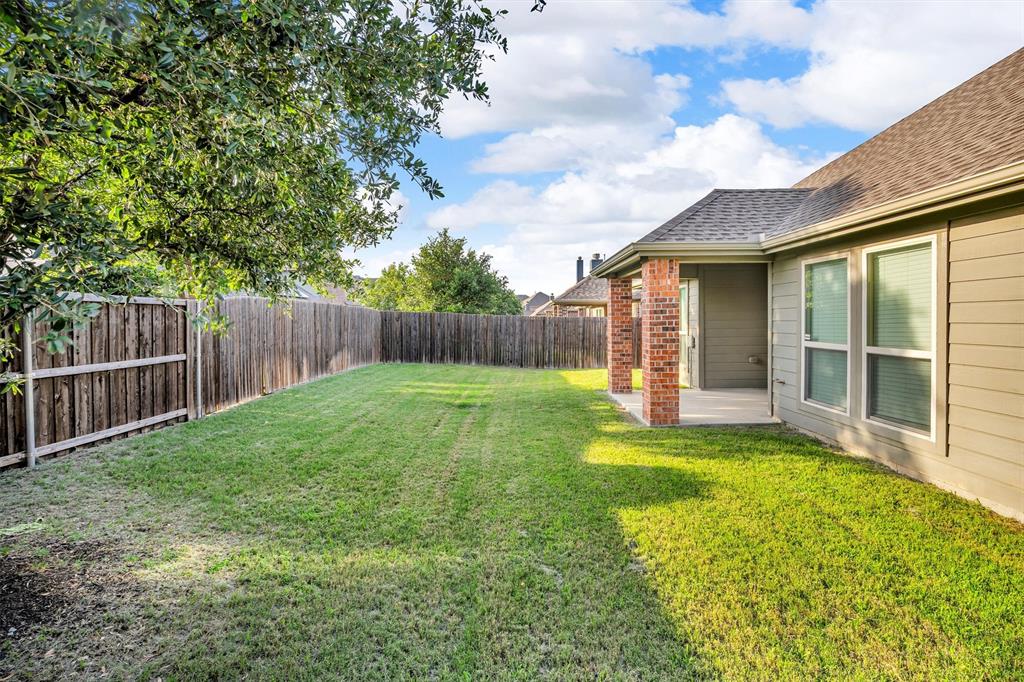 520 Rustic Oak Lane McKinney, TX 75072 - Photo 35 of 37 a view of a backyard with a garden and deck