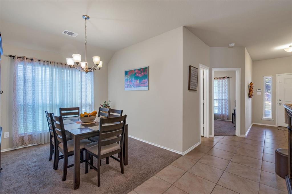 520 Rustic Oak Lane McKinney, TX 75072 - Photo 6 of 37 a view of a dining room with furniture and chandelier
